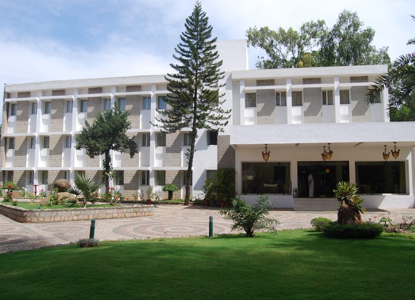 The Ashhok Hassan hotel exterior with landscaped gardens
