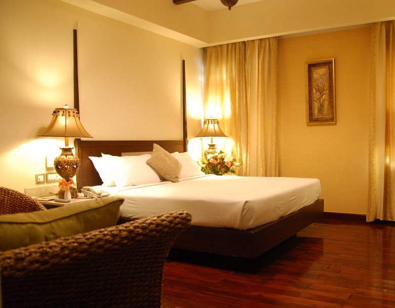 Deluxe room with warm lighting at The Ashhok Hassan